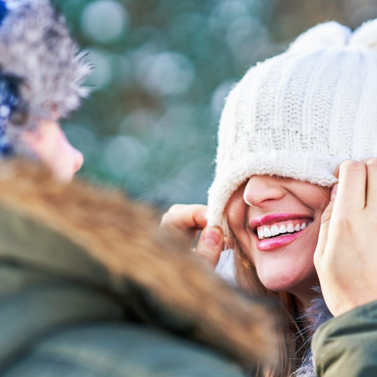 Couple having fun in winter scenery and snow. High quality photo