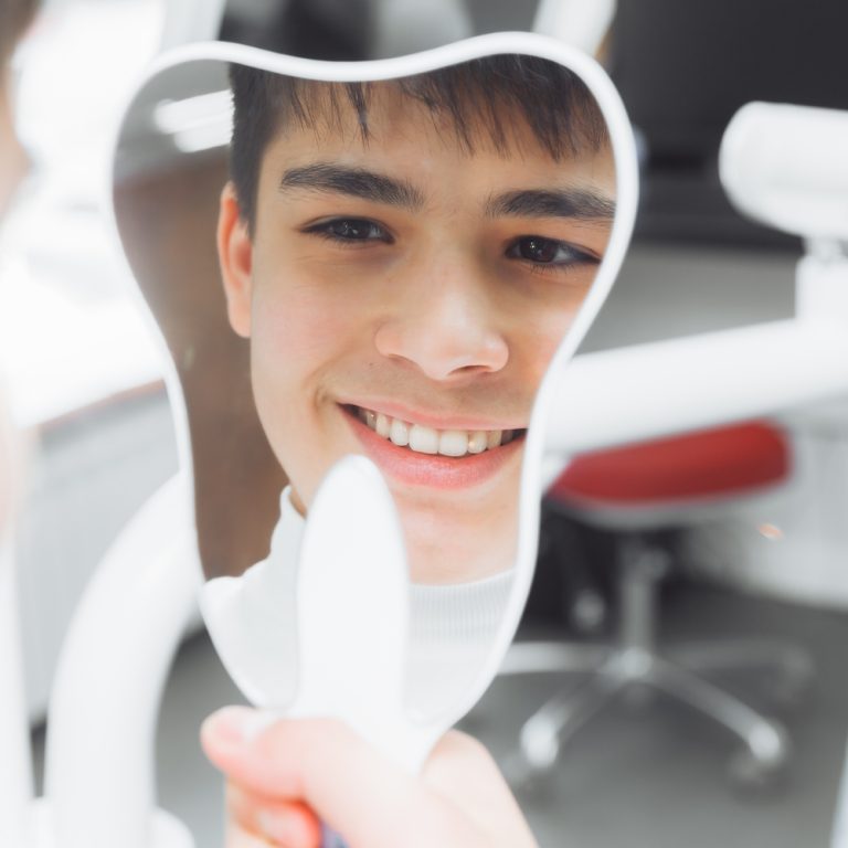 boy-looks-in-the-mirror-with-a-toothy-smile-sitti-2025-03-08-06-22-56-utc