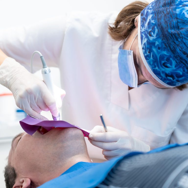 Dental clinic, a doctor performing a root canal to a patient in full operation