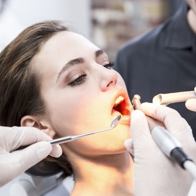 Young woman at the dentist receiving treatment